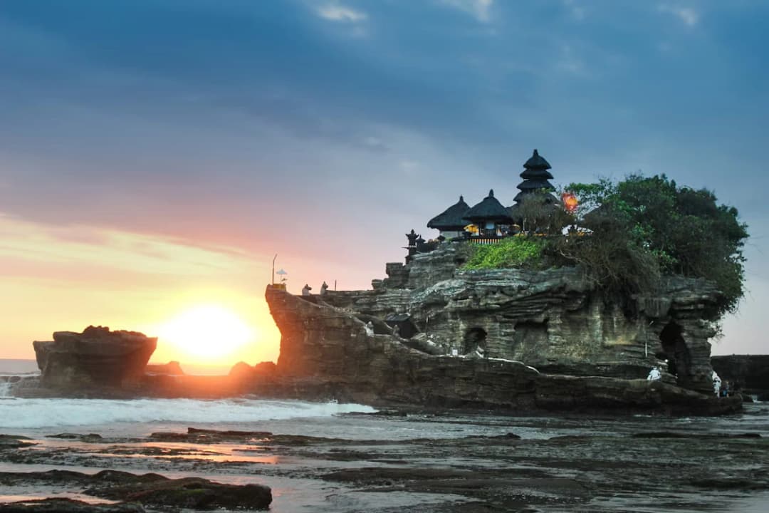 Pura Tanah Lot sea temple perched on a rock at sunset, Bali, Indonesia